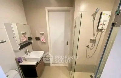 Modern bathroom with sleek design and glass shower enclosure.