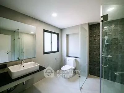 Modern bathroom with sleek design, glass shower, and contemporary fixtures.