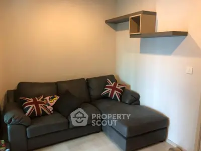 Cozy living room with stylish sofa and modern shelving, perfect for relaxation and comfort.