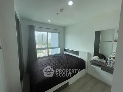 Modern bedroom with large window and city view, featuring sleek furniture and minimalist design.