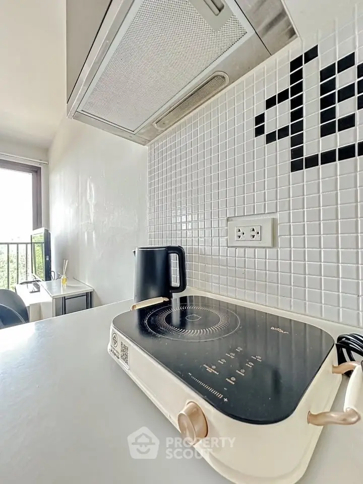 Modern kitchen with sleek induction cooktop and stylish backsplash
