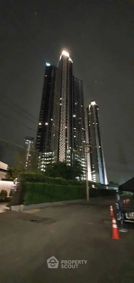 Stunning night view of a modern high-rise building with illuminated facade.