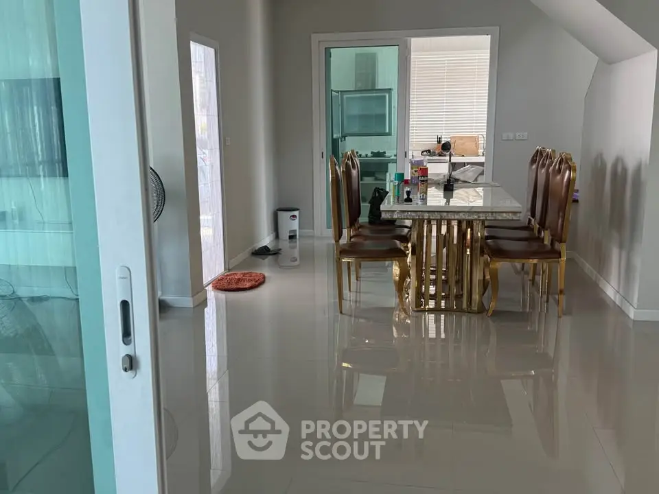 Elegant dining room with glossy floors and luxurious gold-accented table set