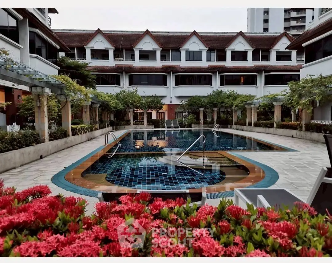 Luxurious residential complex with a stunning outdoor pool and lush landscaping.