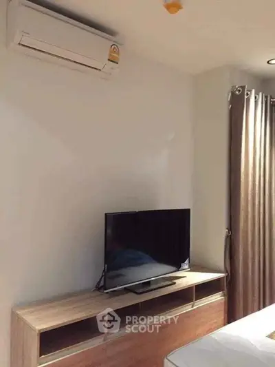 Modern bedroom with air conditioning and sleek TV setup