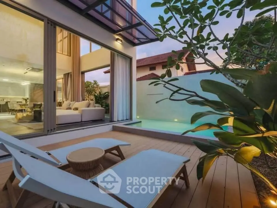 Luxurious modern home with poolside deck and elegant interior view at sunset.