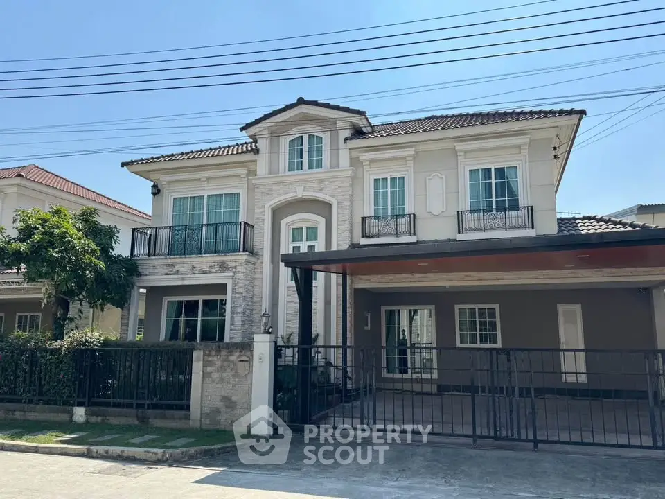 Elegant two-story house with classic architecture and spacious driveway in a serene neighborhood.