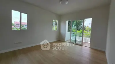 Spacious empty room with large windows and balcony access, perfect for customization.