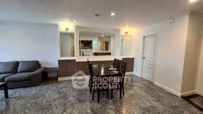 Spacious open-plan living and dining area with modern furnishings and marble flooring.