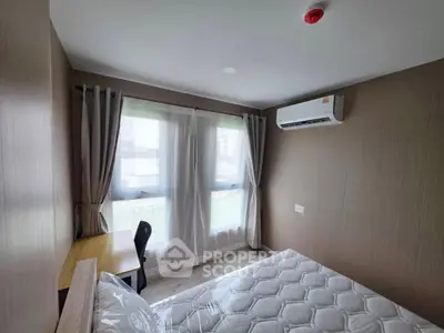 Modern bedroom with large windows, air conditioning, and a study desk, perfect for comfort and productivity.