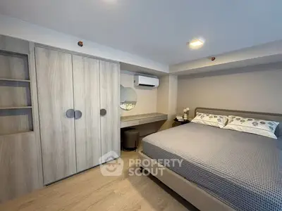 Modern bedroom with stylish furniture and ample storage space