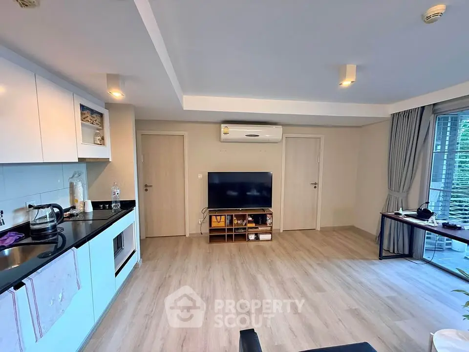 Modern living room with open kitchen and sleek design