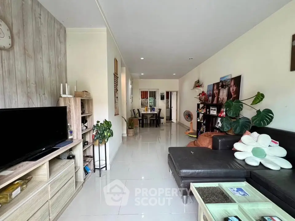 Spacious living room with modern decor and comfortable seating in a stylish apartment.