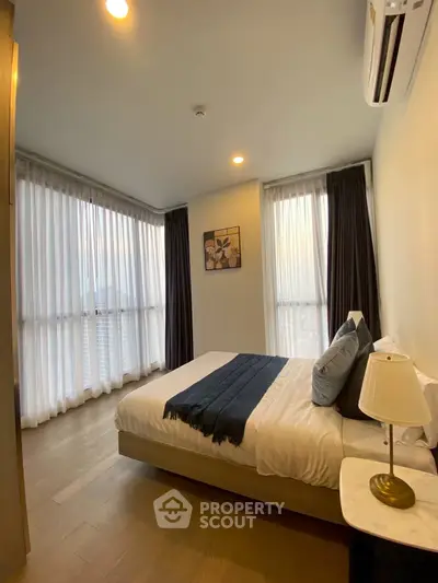 Modern bedroom with large windows and stylish decor