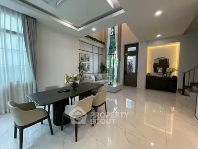 Luxurious open-plan living and dining area with high ceilings and elegant decor