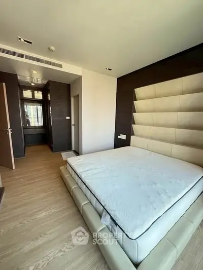 Luxurious modern bedroom with stylish decor and ample natural light
