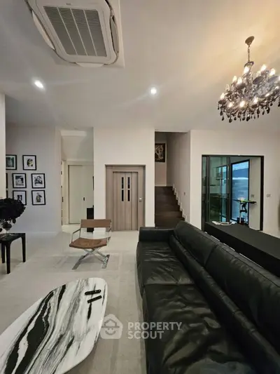Luxurious living room with elegant chandelier and modern decor
