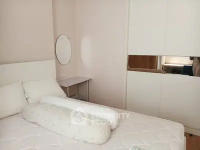 Cozy bedroom with modern white furniture and ample natural light