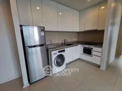 Modern kitchen with sleek appliances and ample storage space