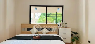 Bright bedroom with large window and modern decor