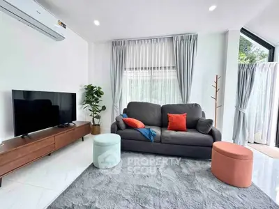 Modern living room with stylish decor and large windows for natural light