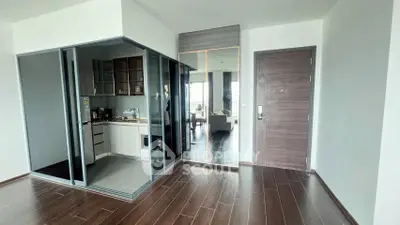 Modern apartment interior with glass-enclosed kitchen and wooden flooring