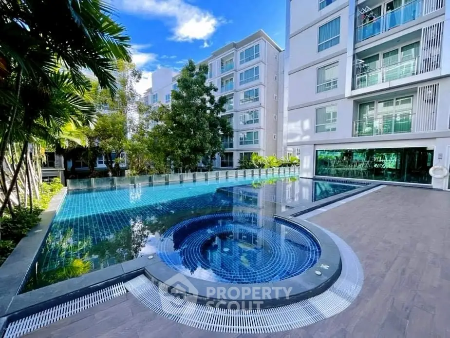 Luxurious residential complex with stunning pool and modern architecture.
