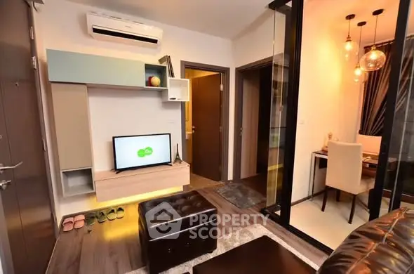 Modern living room with stylish decor and adjacent study area