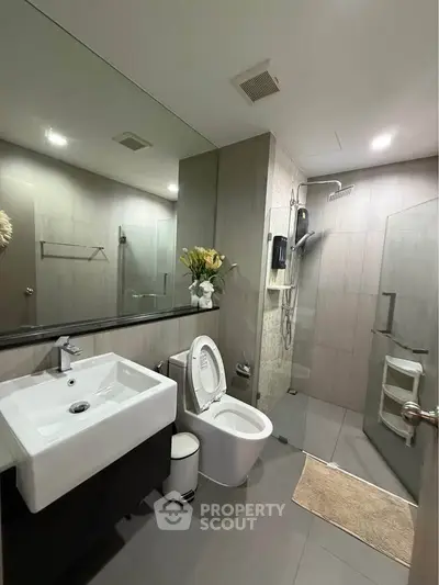 Modern bathroom with sleek fixtures and glass shower enclosure
