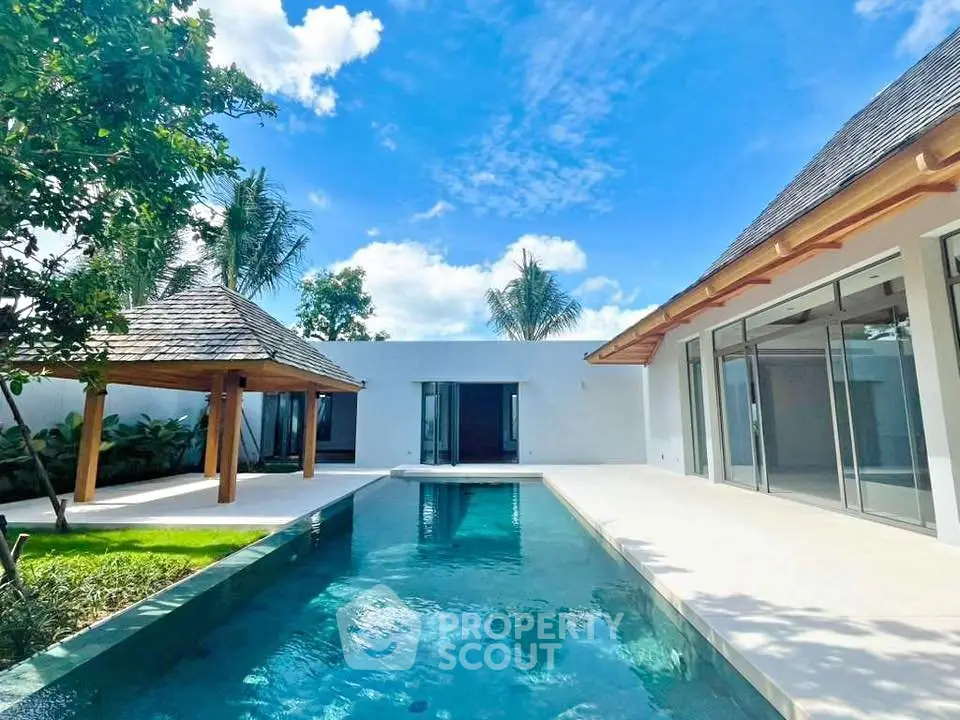 Luxurious modern villa with private pool and lush garden, perfect for tropical living.