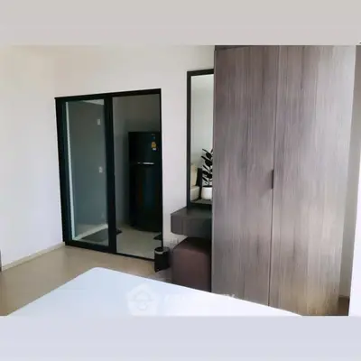 Modern bedroom with sleek wardrobe and minimalist decor in a contemporary apartment.