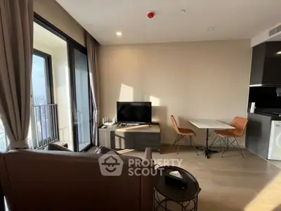 Modern living room with balcony view and stylish furniture in high-rise apartment