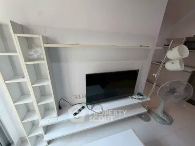 Modern living room with sleek TV stand and minimalist shelving unit