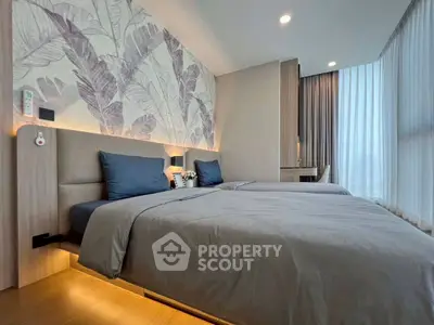 Modern bedroom with twin beds, stylish wallpaper, and floor-to-ceiling windows for natural light.