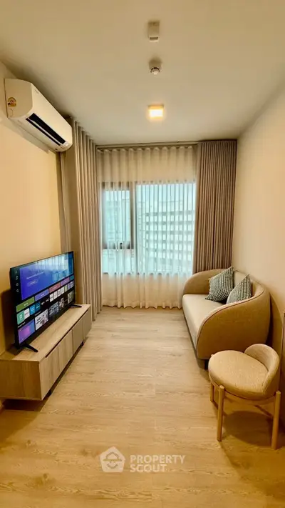 Modern living room with cozy sofa, TV, and large window with city view.