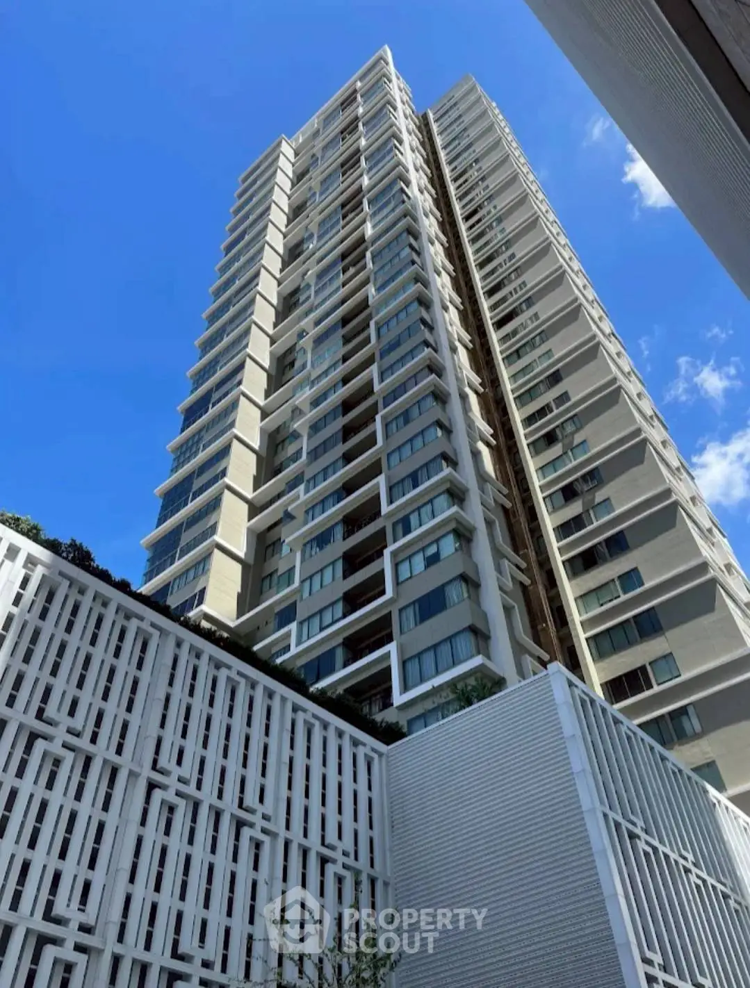 Stunning modern high-rise building with sleek architectural design against a clear blue sky.
