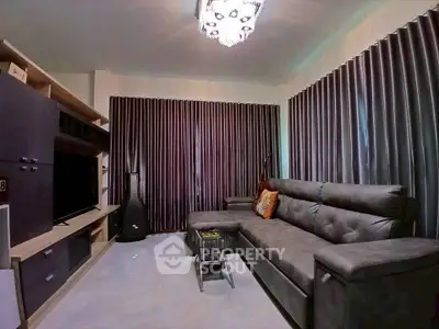 Modern living room with sleek furniture and elegant curtains