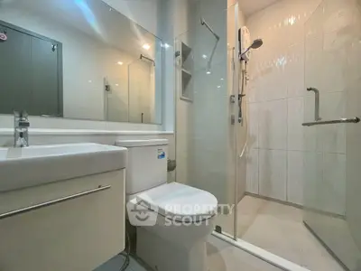 Modern bathroom with glass shower enclosure and sleek fixtures