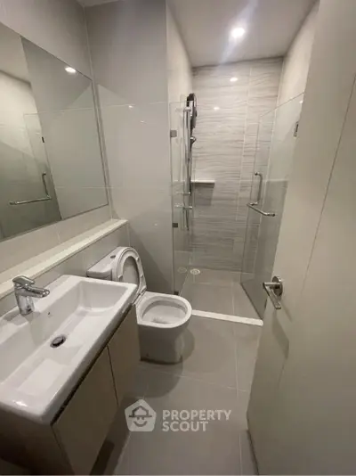 Modern bathroom with sleek design, glass shower, and contemporary fixtures.