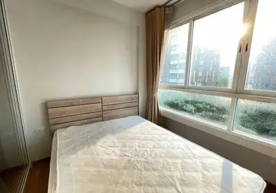 Bright bedroom with large window and modern furnishings