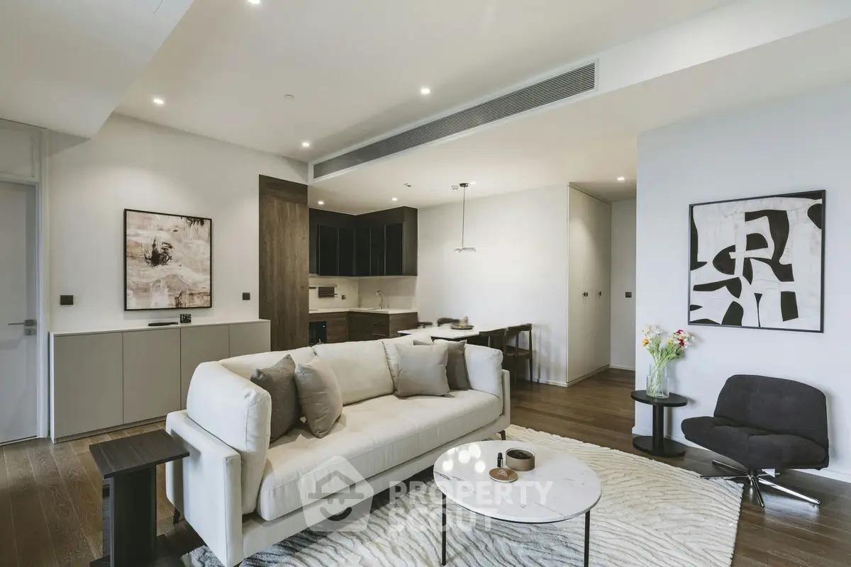 Modern living room with stylish decor and open kitchen layout in luxury apartment.