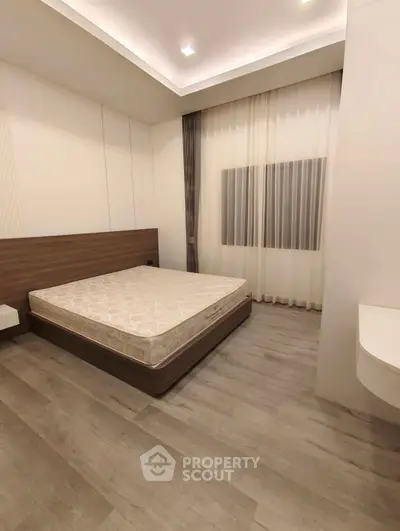 Modern bedroom with minimalist design and wooden flooring