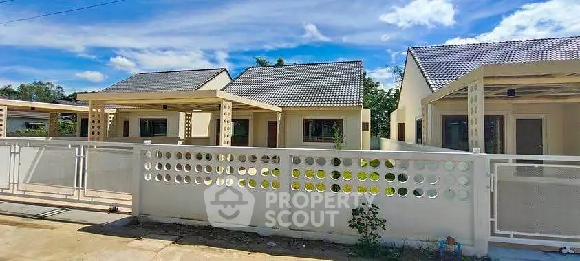 Charming suburban homes with modern design and spacious yards under a clear blue sky.