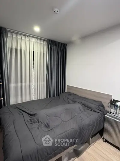 Cozy modern bedroom with stylish gray bedding and sleek curtains