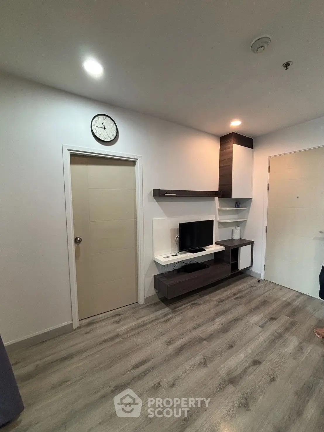 Modern living room with sleek TV unit and wooden flooring
