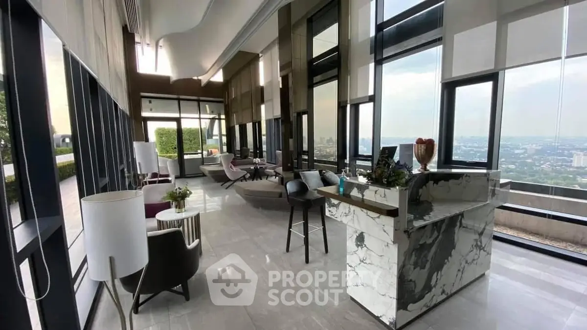 Luxurious high-rise living room with panoramic city views and elegant marble decor.