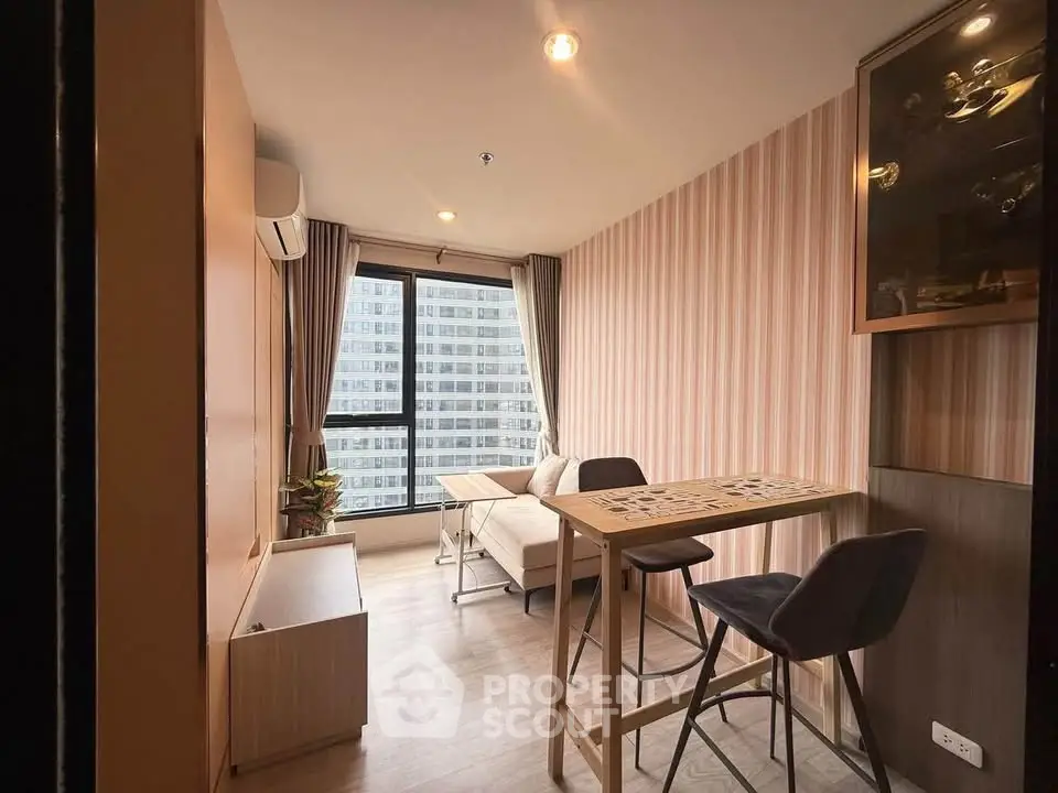 Modern living room with stylish decor and city view, featuring a cozy seating area and dining space.