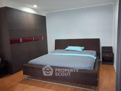 Spacious bedroom with modern furnishings and ample closet space