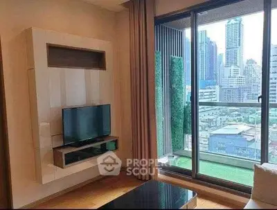 Modern living room with city view and sleek TV setup in high-rise apartment.