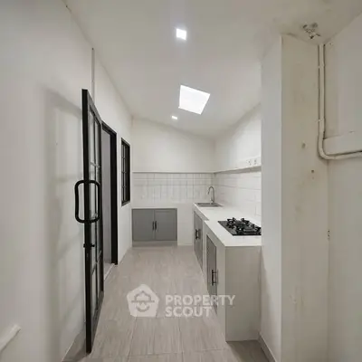 Modern kitchen with sleek design, featuring gas stove and ample storage space.